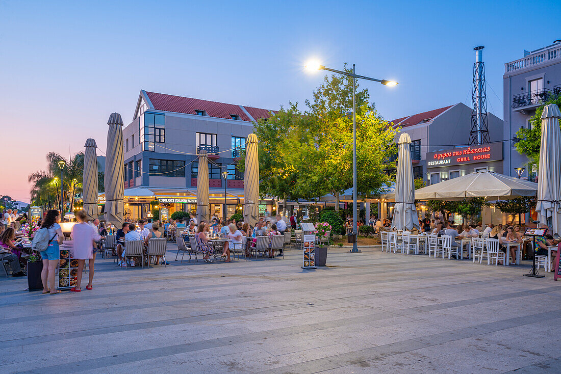 View of restaurant in Vallianou Square at dusk, capital of Cephalonia, Argostolion, Kefalonia, Ionian Islands, Greek Islands, Greece, Europe\n