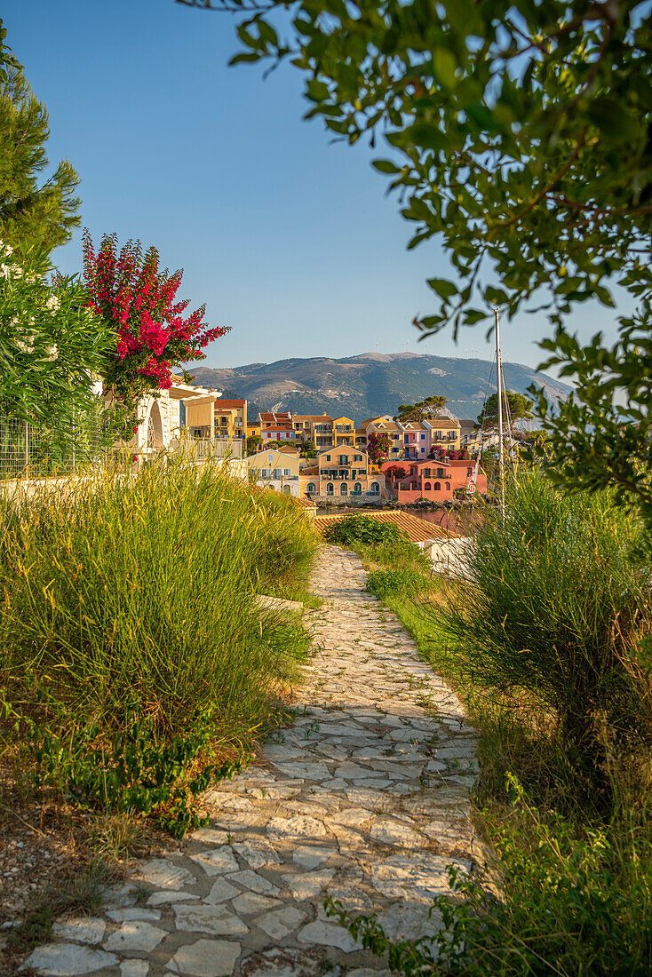 Path leading to harbour and colourful houses in Assos, Assos, Kefalonia, Ionian Islands, Greek Islands, Greece, Europe\n