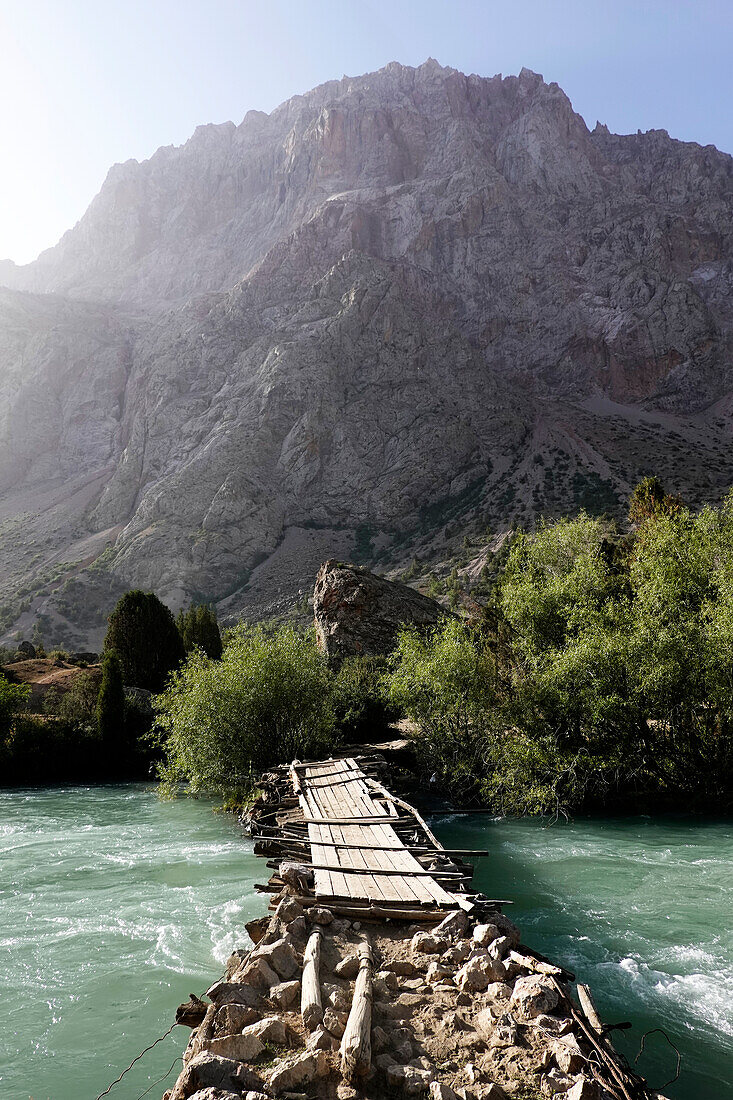 Wooden bridge over a river in the remote and spectacular Fann Mountains, part of the western Pamir-Alay, Tajikistan, Central Asia, Asia\n