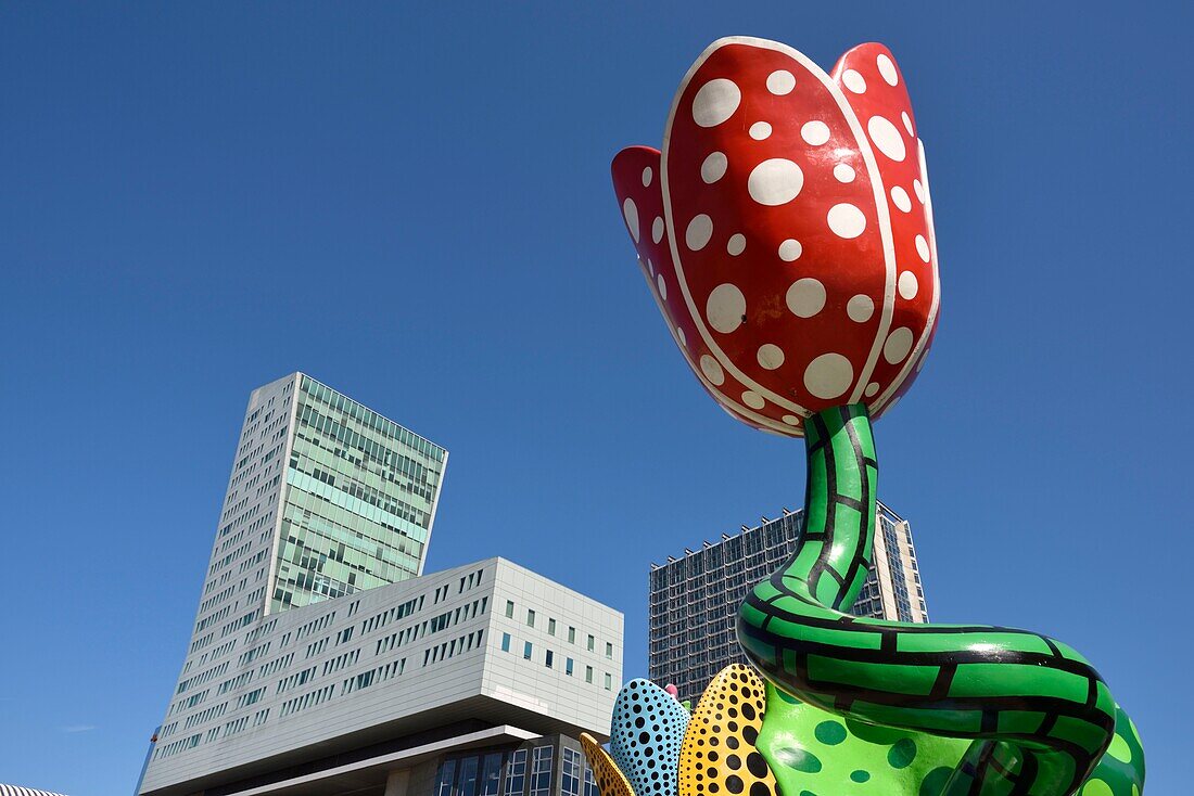 France, Nord, Lille, Euralille area, esplanade François Mitterrand, work entitled The Tulips of Shangri-La, permanent sculpture of Yayoi Kusama, dominated by the tower of Lille and the Lilleurope tower\n