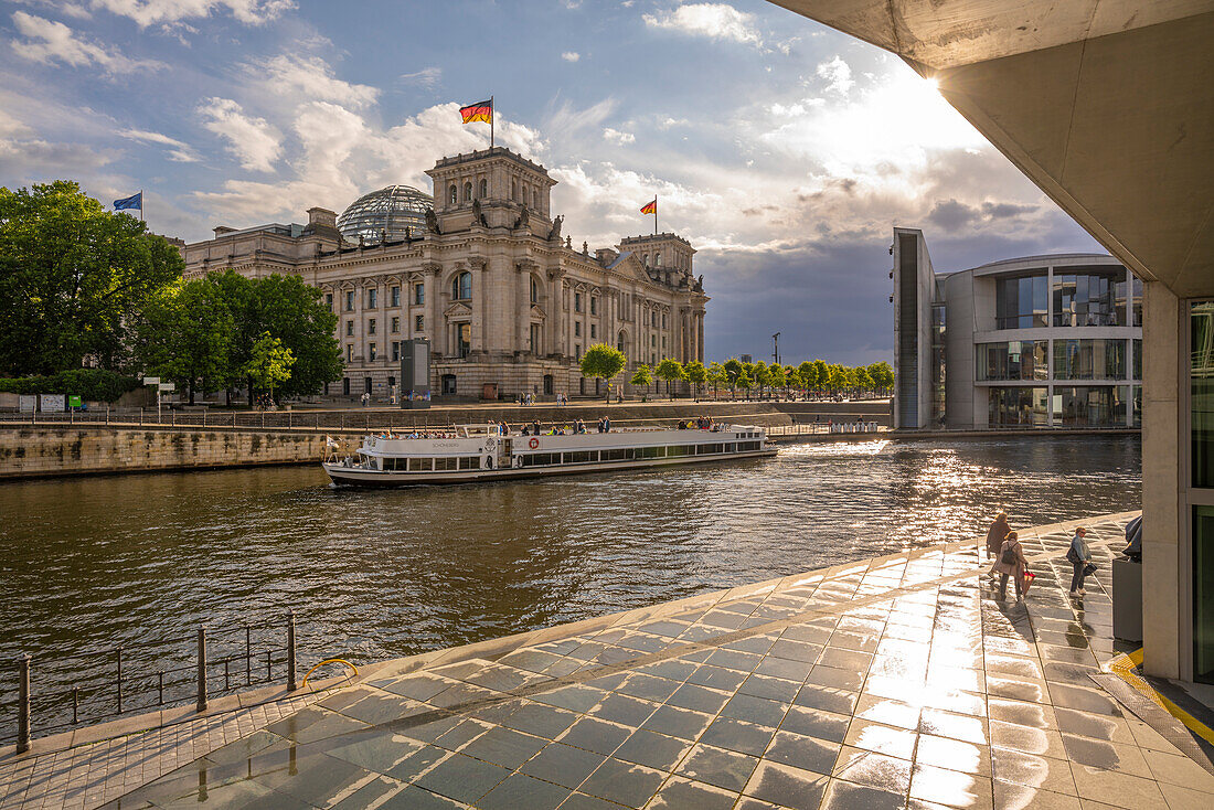 View of sightseeing cruise boat on River Spree and the Reichstag (German Parliament building), Mitte, Berlin, Germany, Europe\n