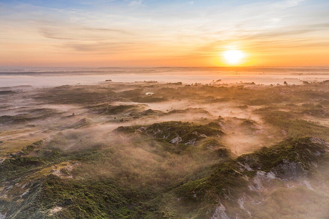 "France, Somme, Bay of Authie, Fort-Mahon, the dunes of Marquenterre at sunrise while the mist still nestles between the dunes; view between Fort Mahon and Authie Bay"\n