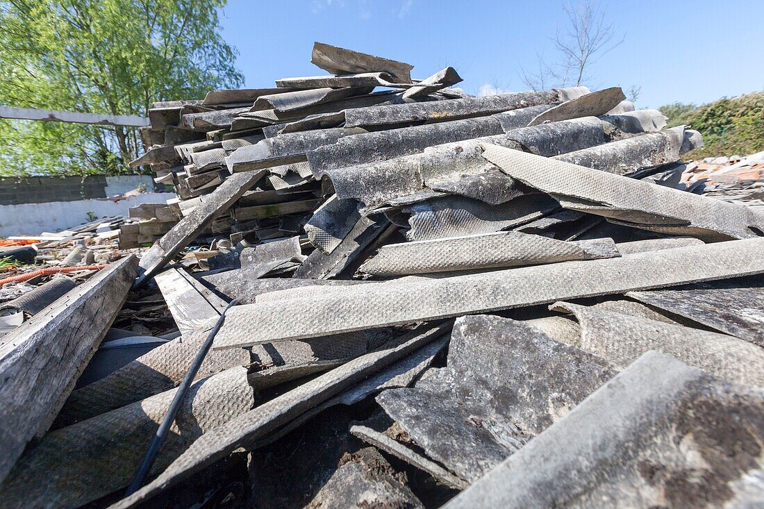 France, Vienne, Chatellerault, demolition site with an asbestos issue, piles of broken corrugated sheets made of asbestos cement\n