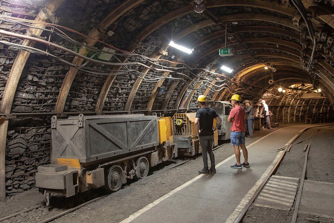 France, North, Lewarde, Historic mining center installed on the site of the old Delloye pit classified as World Heritage by UNESCO, visit to the reconstructed mine, 2 men looking at a wagon\n