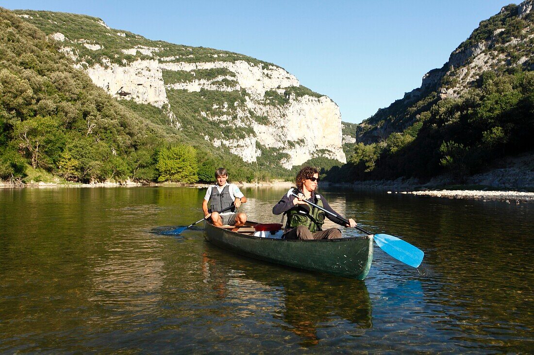 France, Ardeche, Ardeche Gorges National Natural Reserve, Sauze, a gard of the natural reserve makes its morning watch on a canoe in the Ardeche canyon\n