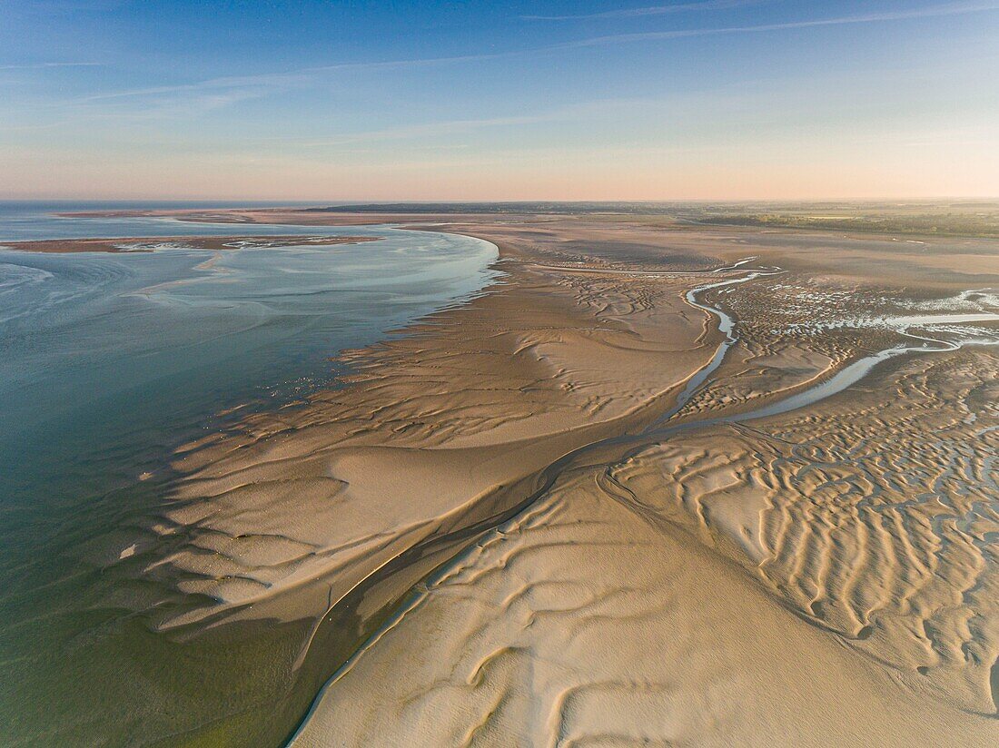 France, Somme, Baie de Somme, Le Crotoy, the Bay of Somme at low tide in the early morning, the nature reserve and the ornithological park of Marquenterre in the background (aerial view)\n