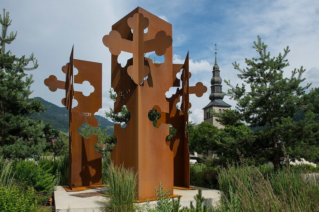 France, Haute Savoie, massif of Chablais, Val d'Abondance, Portes du Soleil, Abondance Chapel, a sculpture representing 3 totems with the symbolized form of the cross of Saint Maurice at the entrance of the village\n
