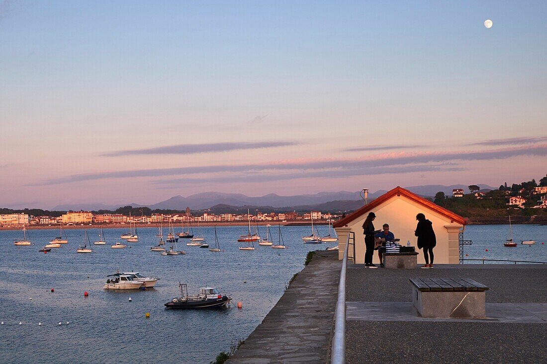 France, Pyrenees Atlantiques, Basque Country coast, Ciboure, Guitarist on the dike of Socoa fort in the bay of Saint Jean de Luz\n