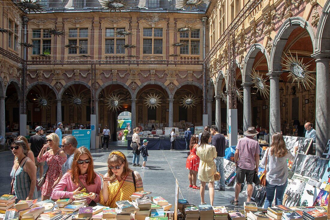 France, Nord, Lille, old stock exchange, tourists looking at books of booksellers\n