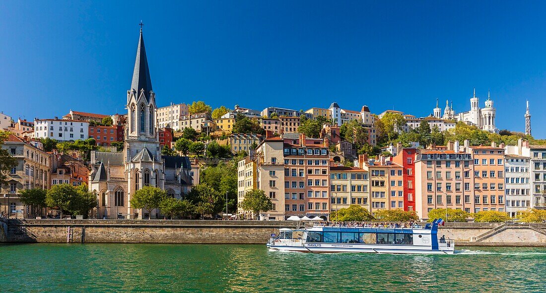 France, Rhone, Lyon, historic district listed as a UNESCO World Heritage site, Old Lyon, Quai Fulchiron on the banks of the Saone river, Saint Georges church and the Notre-Dame de Fourviere basilica on the Fourviere hill, electric propulsion restaurant boat\n