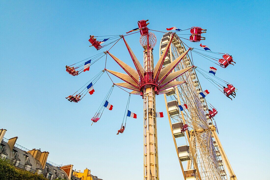 France, Paris, Tuileries garden, Fun Fair, Carousel and Ferris Wheel\n