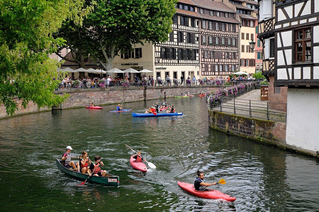 France, Bas Rhin, Strasbourg, old town listed as World Heritage by UNESCO, Place Benjamin Six, from the swing bridge on the Ill river, canoe kayak, half timbered houses\n