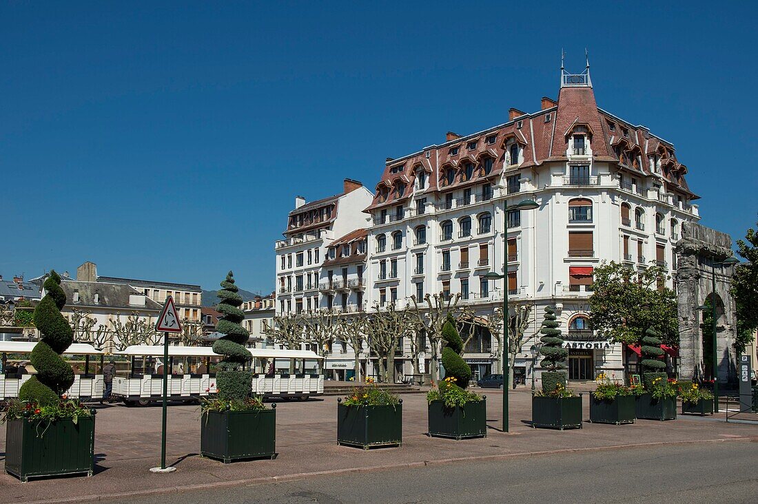 France, Savoie, Aix les Bains, Riviera of the Alps, trees sizes in topiary art and small tourist train on the place of the baths and the old hotel Astoria\n