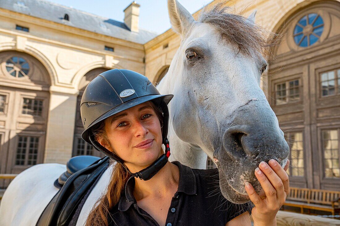 France, Oise, Chantilly, Chantilly Castle, the Great Stables, moment of intimacy between a horsewoman and her horse\n