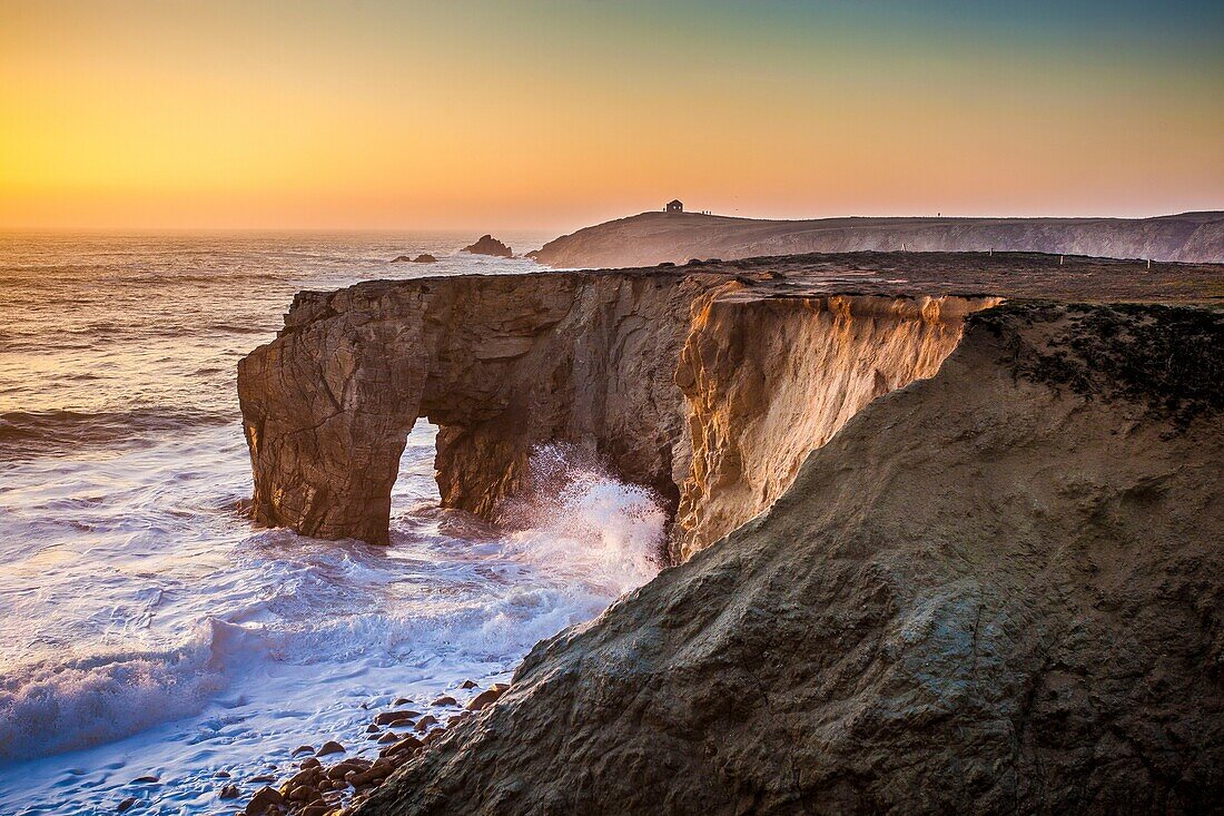France, Morbihan, Quiberon peninsula, Wild Coast, sunset over the arch of Porz Guen, in the distance the tip of Percho and the customs house\n
