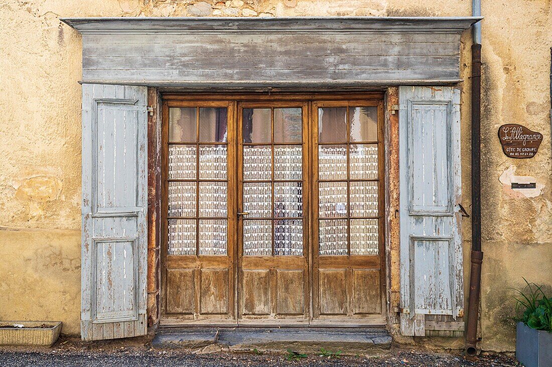 France, Hautes-Alpes , regional natural park of the Baronnies Provençal, Orpierre, glazed entrance door of a former stall\n