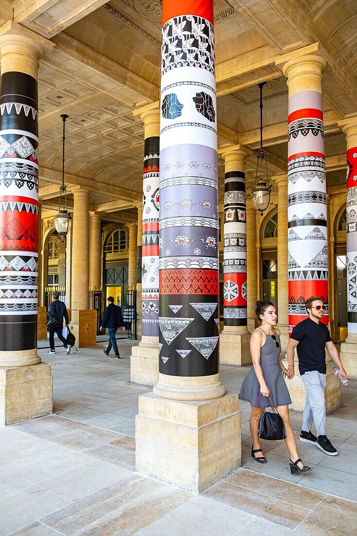 France, Paris, the garden of the Palais Royal, photo exhibition on the columns\n