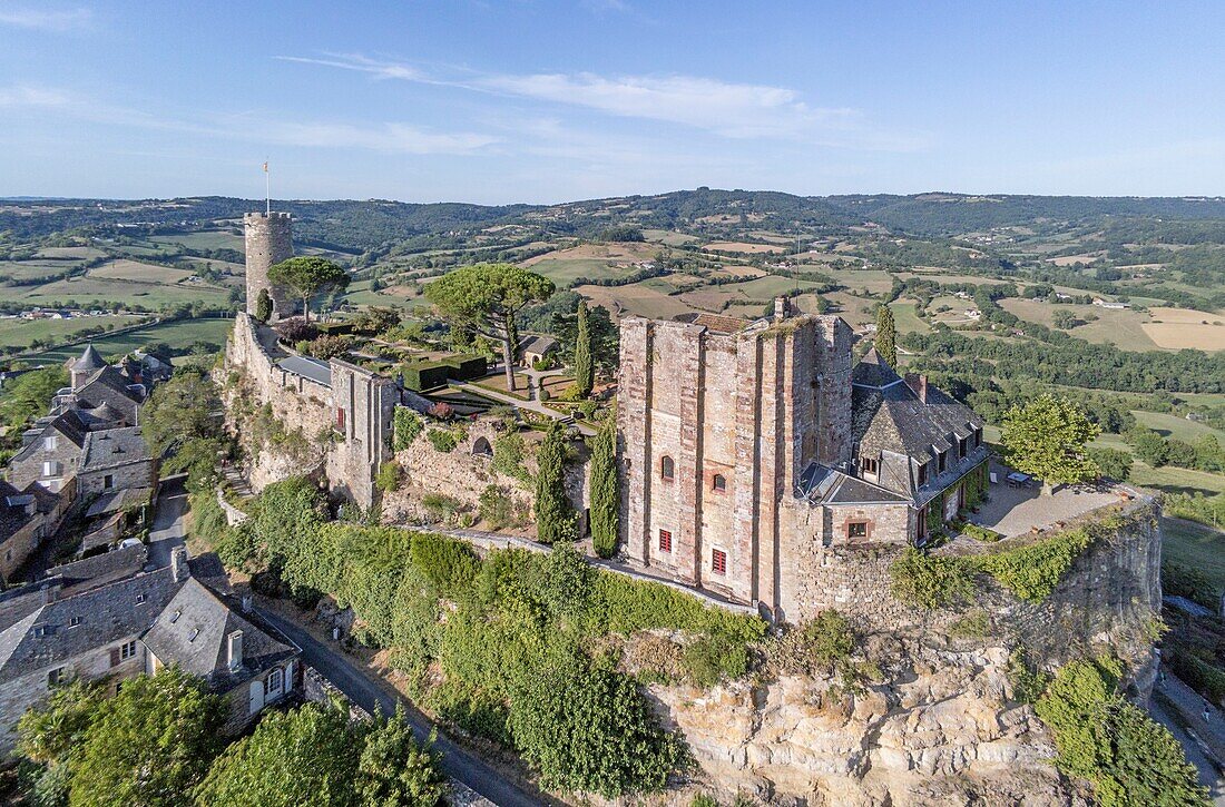 France, Correze, Turenne, labelled Les Plus Beaux Villages de France (The Most Beautiful Villages of France), general view of the village at sunset with Cesar Tower and Tresor Tower or Horloge Tower vestiges of the former fortress (aerial view)\n