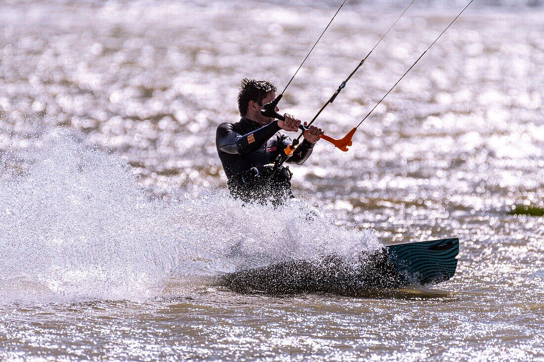 "France, Somme, Bay of the Somme, Le Crotoy, Crotoy beach is a spot for kitesurfing and windsurfing; in the aftermath of a storm, while the sun has returned with a powerful wind, the athletes are numerous and their multicolored sails brighten up the landscape"\n