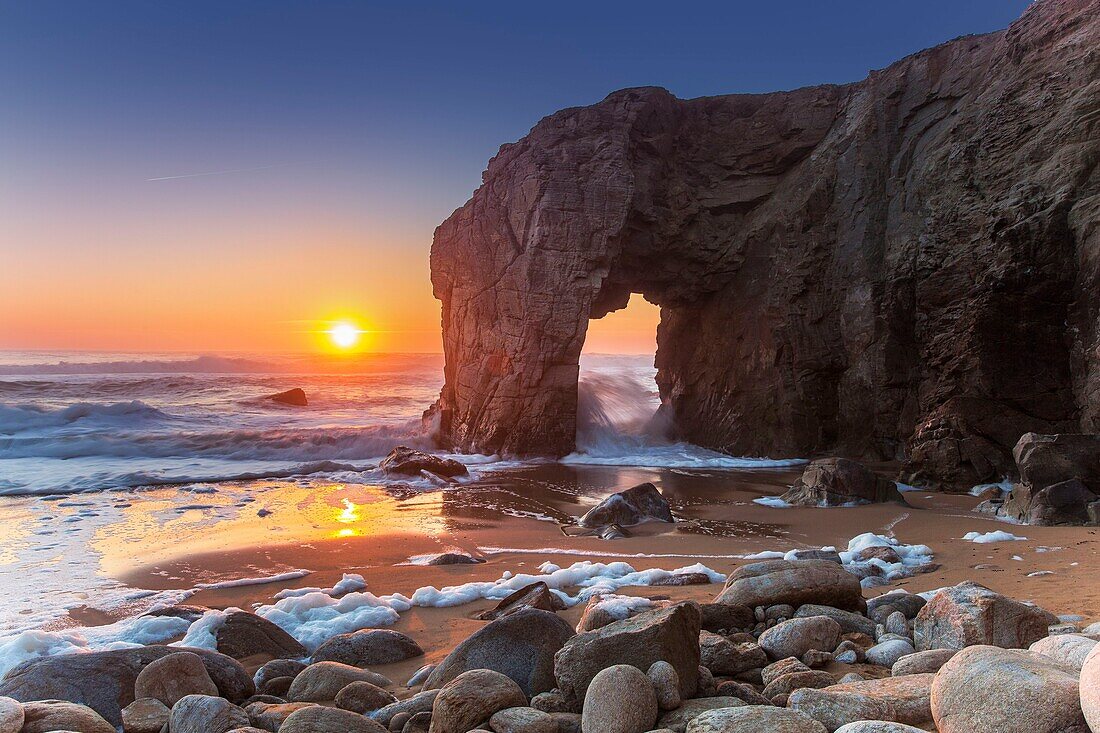 France, Morbihan, Quiberon peninsula, Wild Coast, sunset over the arch of Porz Guen, during high tides in February\n