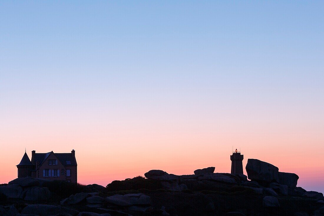 France, Cotes d'Armor, Pink Granite Coast, Perros Guirec, on the Customs footpath or GR 34 hiking trail, Ploumanac'h or Mean Ruz lighthouse at sunset\n