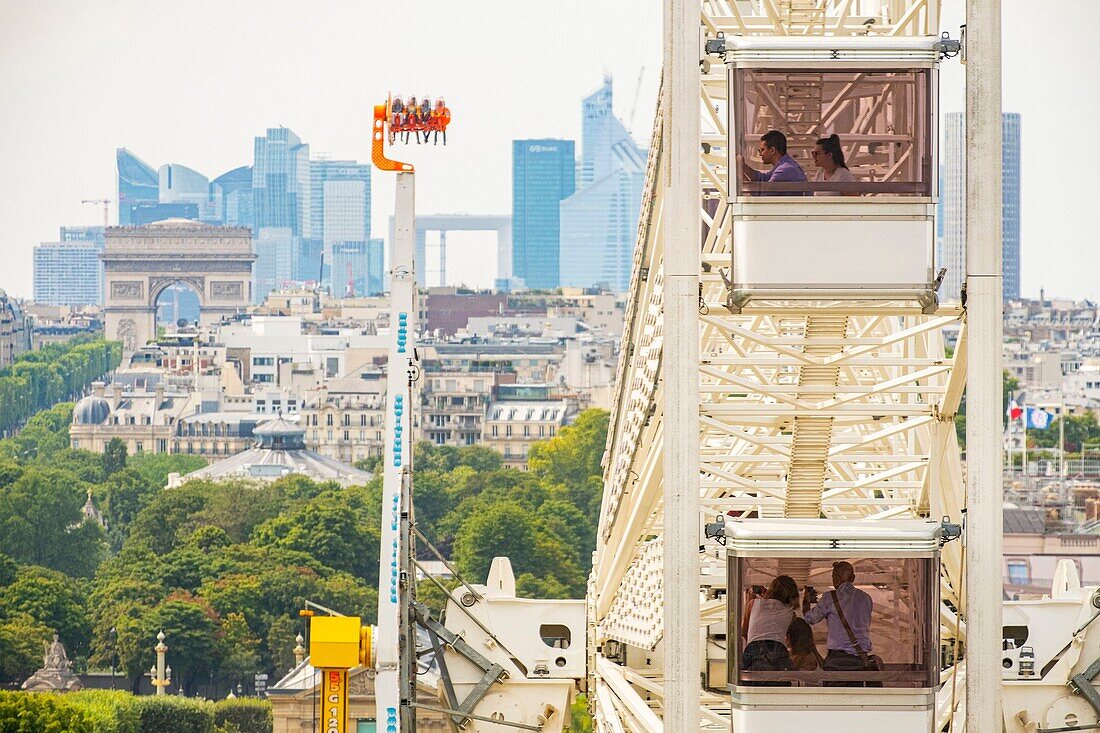 France, Paris, the big Wheel of the travelling funfair and the district of La Defense\n