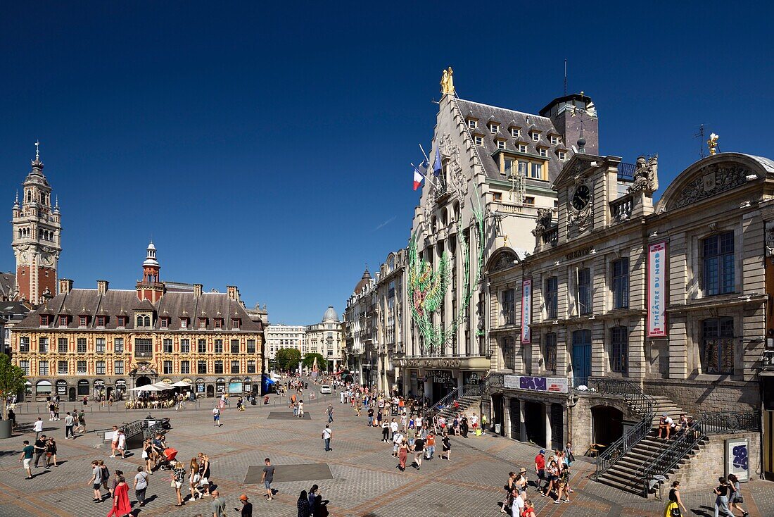 France, Nord, Lille, Place du General De Gaulle or Grand Place, facade of the Theater du Nord and the building housing the offices of the newspaper La Voix Du Nord facing the old stock market and with the belfry of the Chamber of Commerce and Industry in the background\n