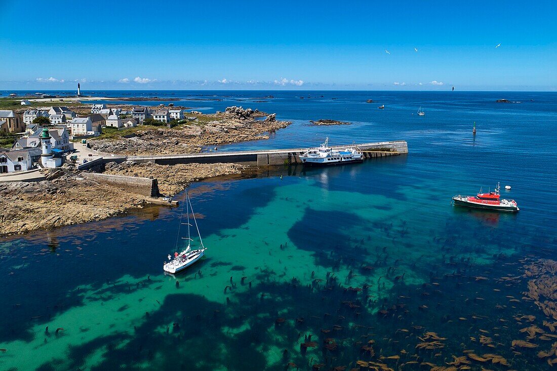 France, Finistere, Iroise Sea, Iles du Ponant, Parc Naturel Regional d'Armorique (Armorica Regional Natural Park), Ile de Sein, labelled Les Plus Beaux de France (The Most Beautiful Village of France), the harbour in front of the village at low tide (aerial view)\n