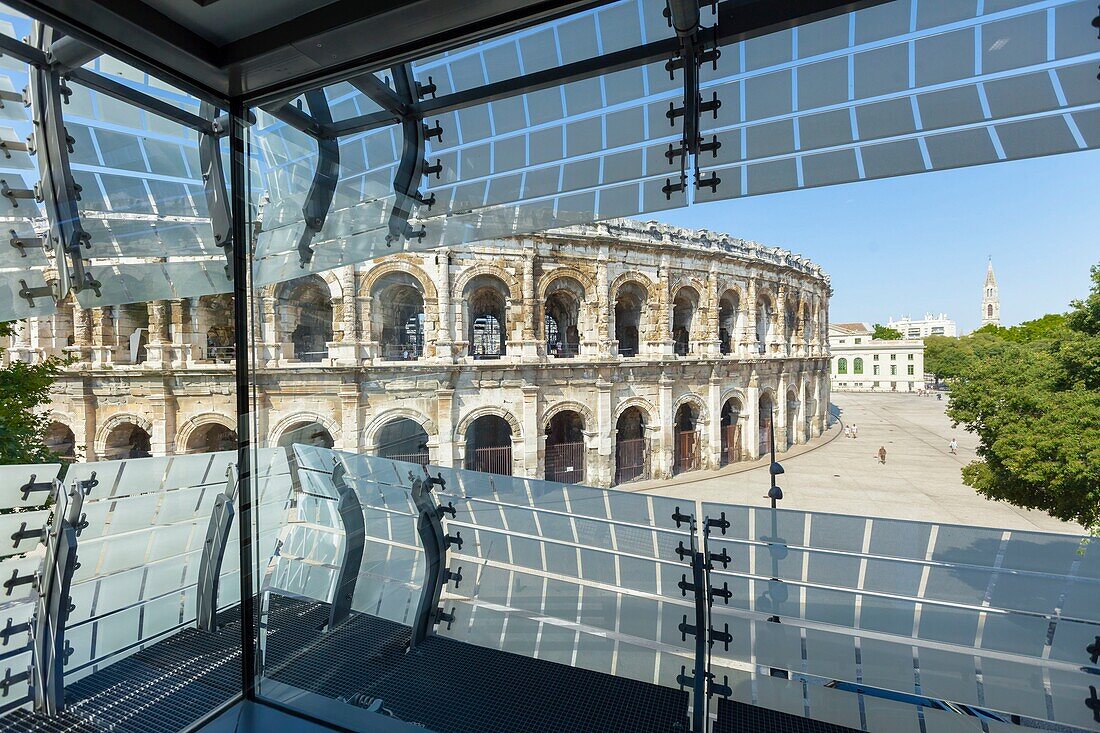 France, Gard, Nimes, Musee de la Romanite by architect Elizabeth de Portzamparc, interior structure of the glass facade and view of the Arena of Nimes\n