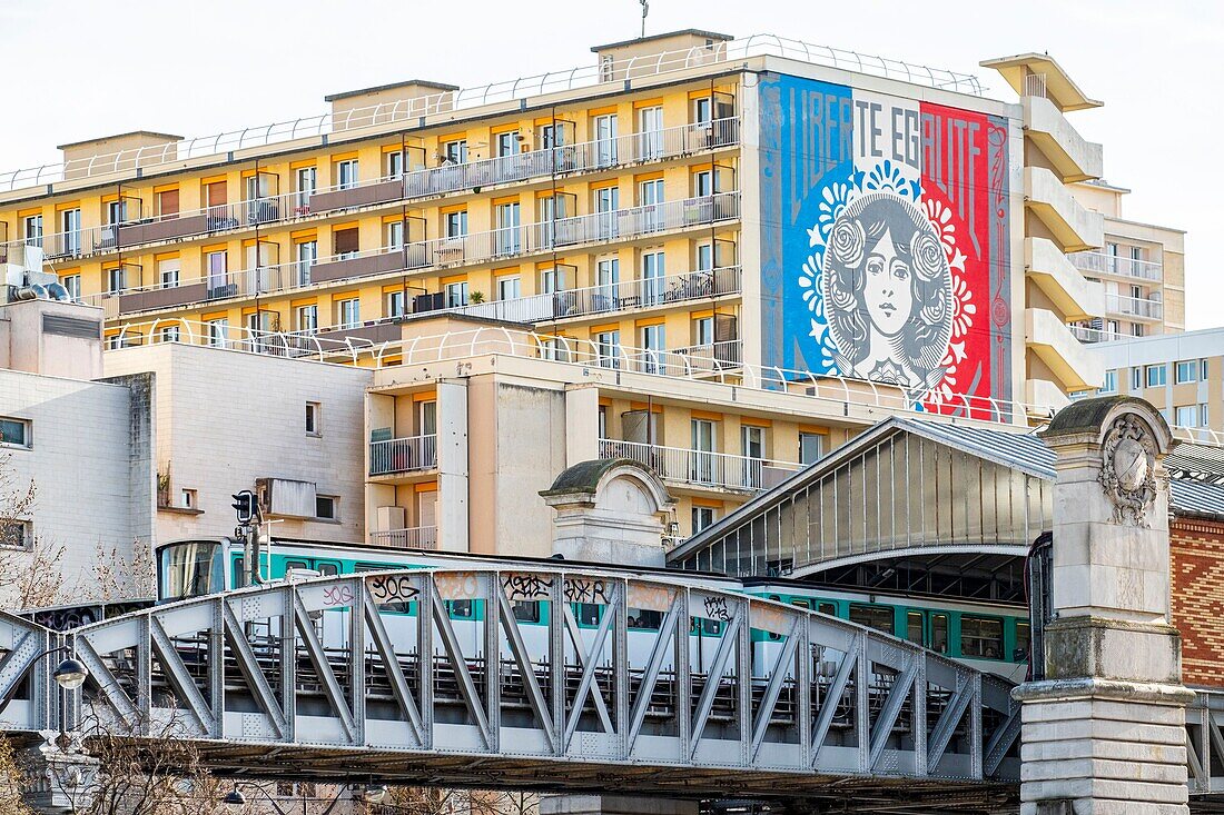 France, Paris, 13th district, Street Art, the underground train line 6 in front of the work Freedom, fresco Equality of © Shepard Fairey\n