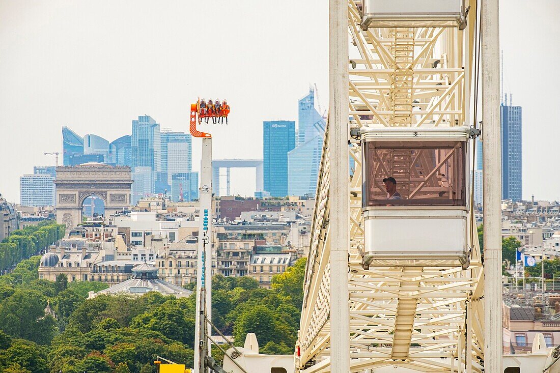 France, Paris, the big Wheel of the travelling funfair and the district of La Defense\n