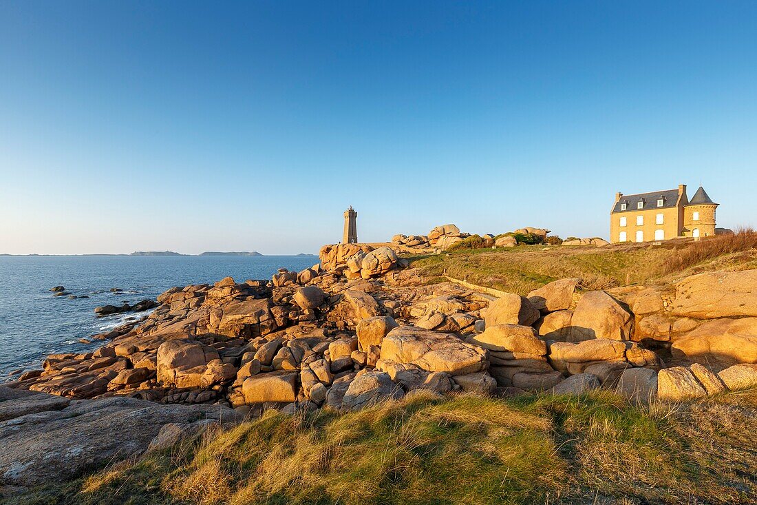 France, Cotes d'Armor, Pink Granite Coast, Perros Guirec, on the Customs footpath or GR 34 hiking trail, Ploumanac'h or Mean Ruz lighthouse at sunset\n