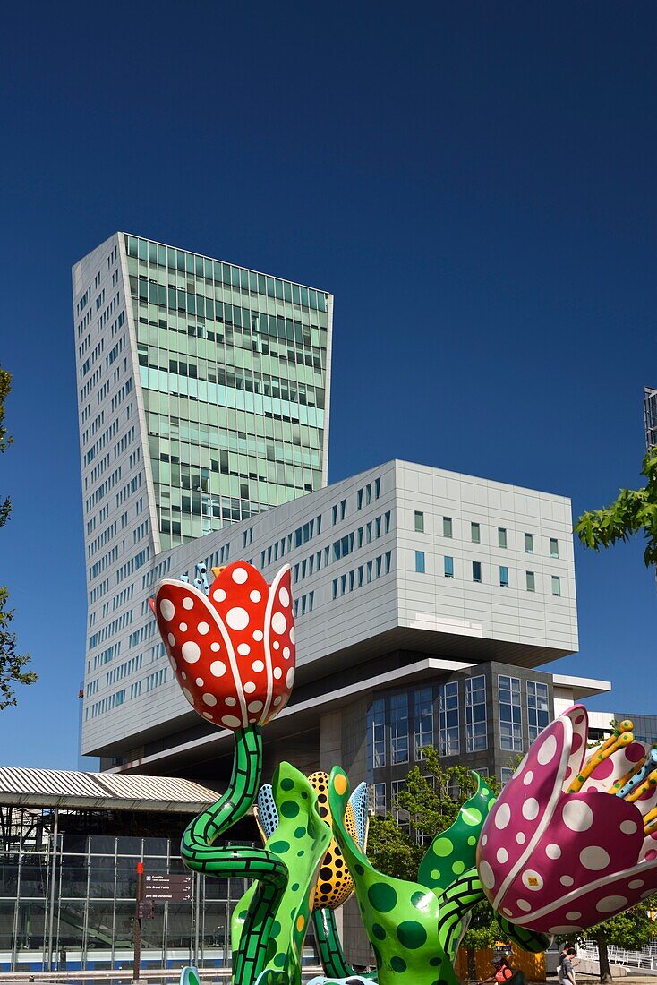 France, Nord, Lille, esplanade Place François Mitterrand with the Euralille business district which includes the Eurostar station and the Lille Europe TGV station, the Lille tower and the work entitled Les Tulipes de Shangri-La, permanent sculpture of Yayoi Kusama\n