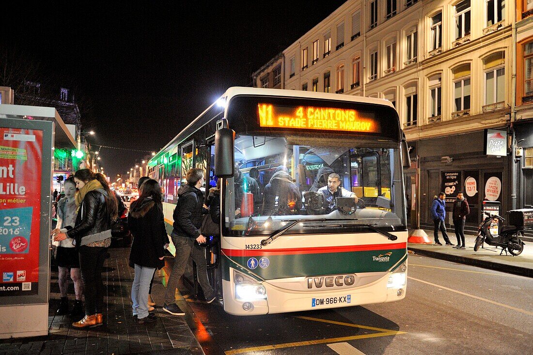 France, Nord, Lille, Solferino street, Ilevia network bus running at night nd passengers boarding the bus\n