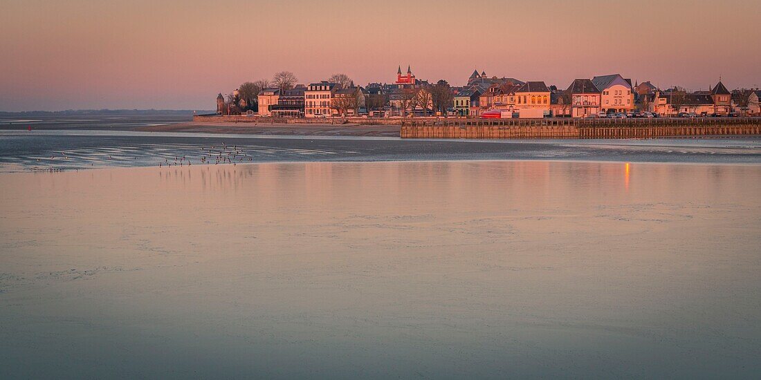 France, Somme, Somme Bay, Le Crotoy, The Somme Bay by cold weather in Winter, view of Le Crotoy in the early morning with frozen water and ice on the ground\n