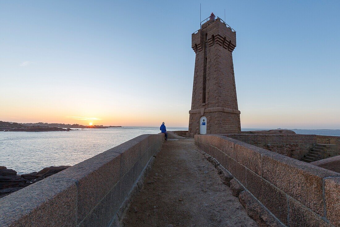 France, Cotes d'Armor, Pink Granite Coast, Perros Guirec, on the Customs footpath or GR 34 hiking trail, Ploumanac'h or Mean Ruz lighthouse at sunset\n