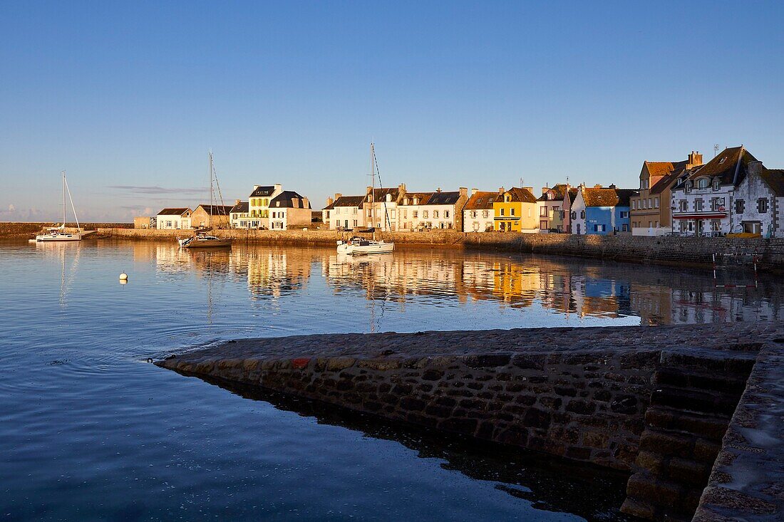 France, Finistere, Iroise Sea, Iles du Ponant, Parc Naturel Regional d'Armorique (Armorica Regional Natural Park), Ile de Sein, labelled Les Plus Beaux de France (The Most Beautiful Village of France), the harbour high tide and the houses on the quay des français libres\n