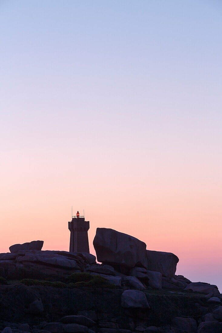 France, Cotes d'Armor, Pink Granite Coast, Perros Guirec, on the Customs footpath or GR 34 hiking trail, Ploumanac'h or Mean Ruz lighthouse at sunset\n