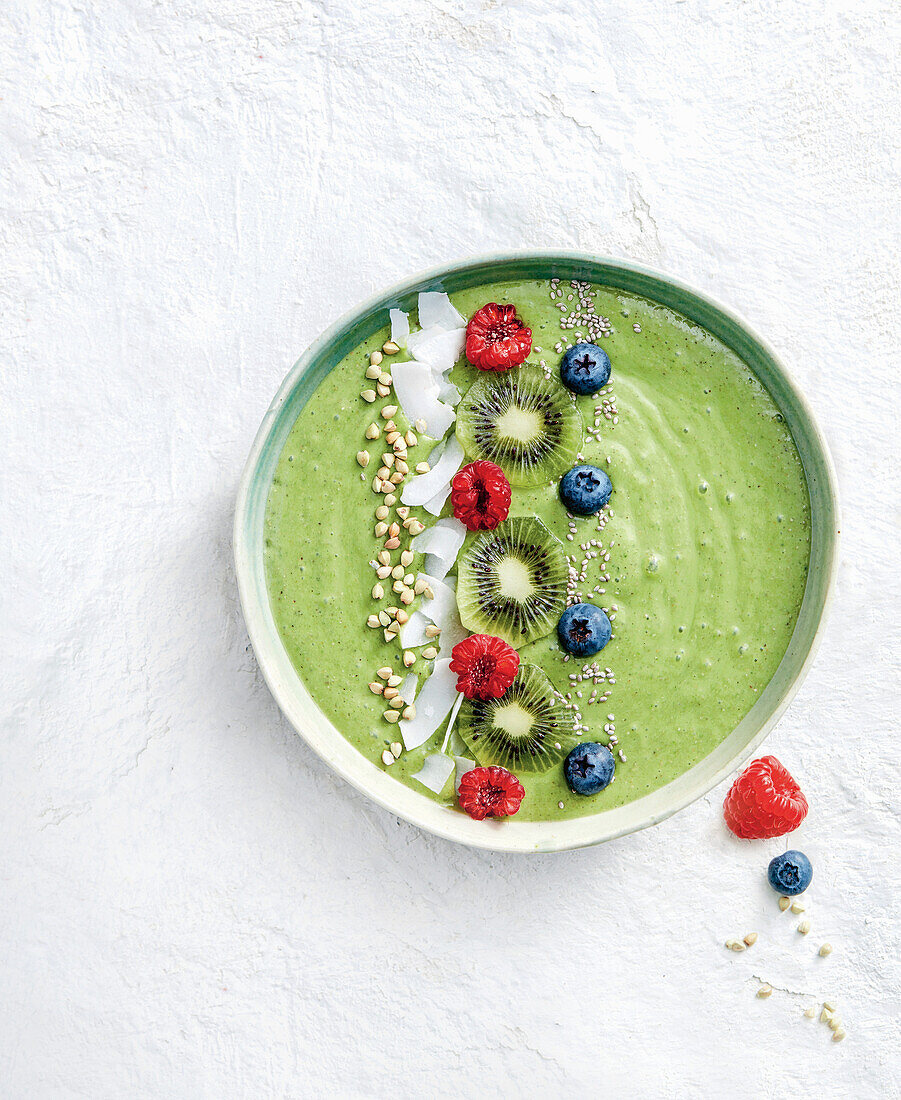 Super green smoothie bowl with coconut and berries