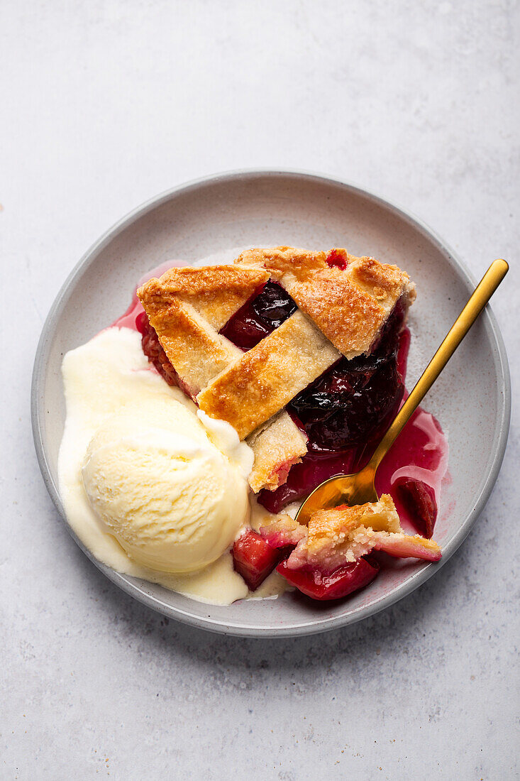 Plum pie with lattice top and ice cream