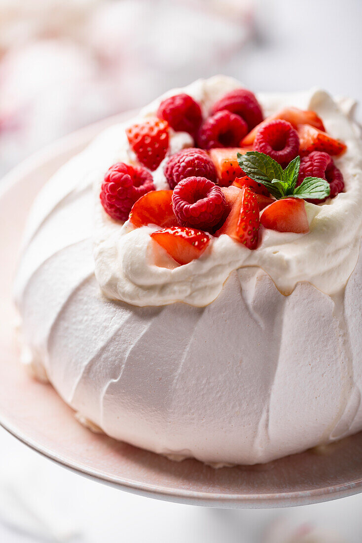 Classic pavlova with whipped cream and fresh berries