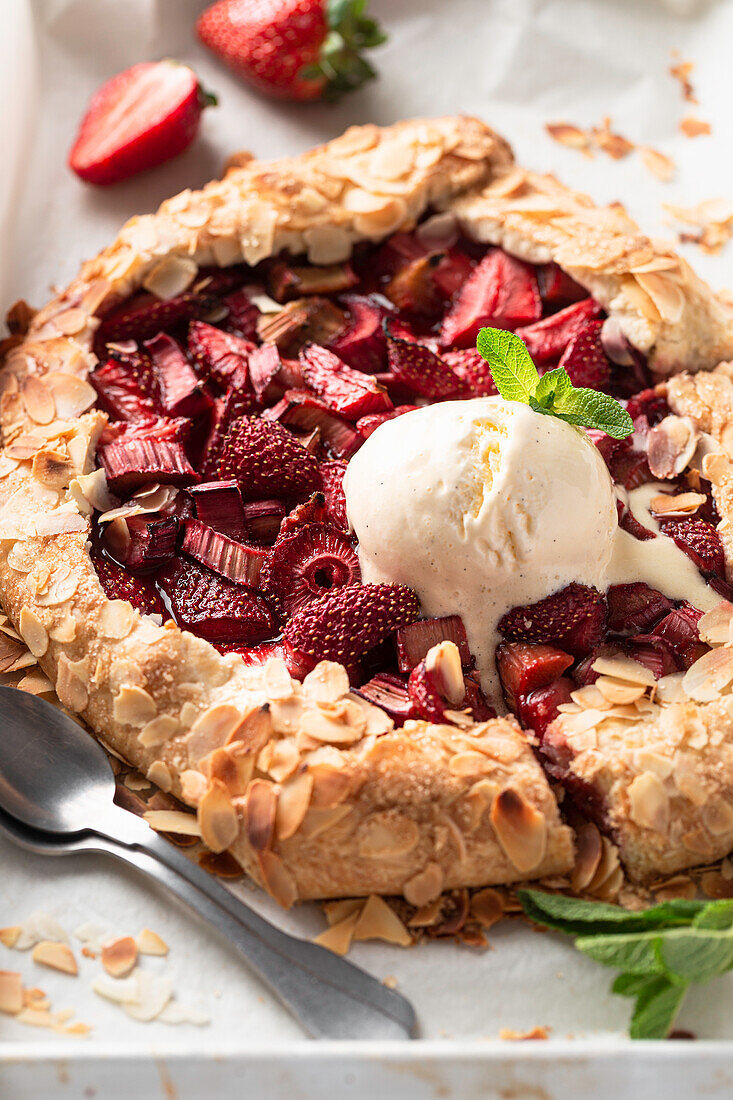 Strawberry and rhubarb galette with almonds and vanilla ice cream