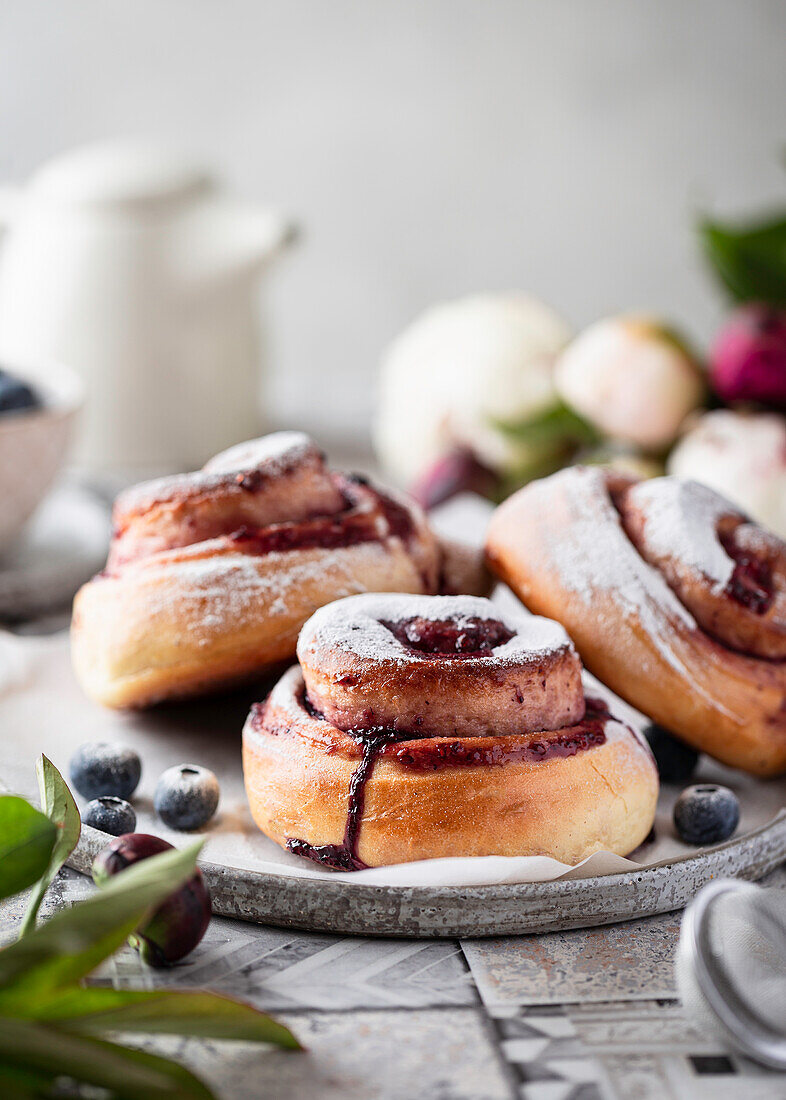 Blueberry buns made from yeast dough with icing sugar