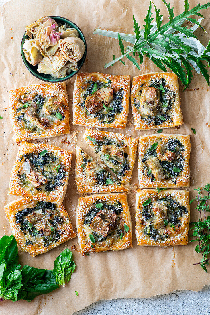 Artichoke puff pastry pies with spinach and cheese