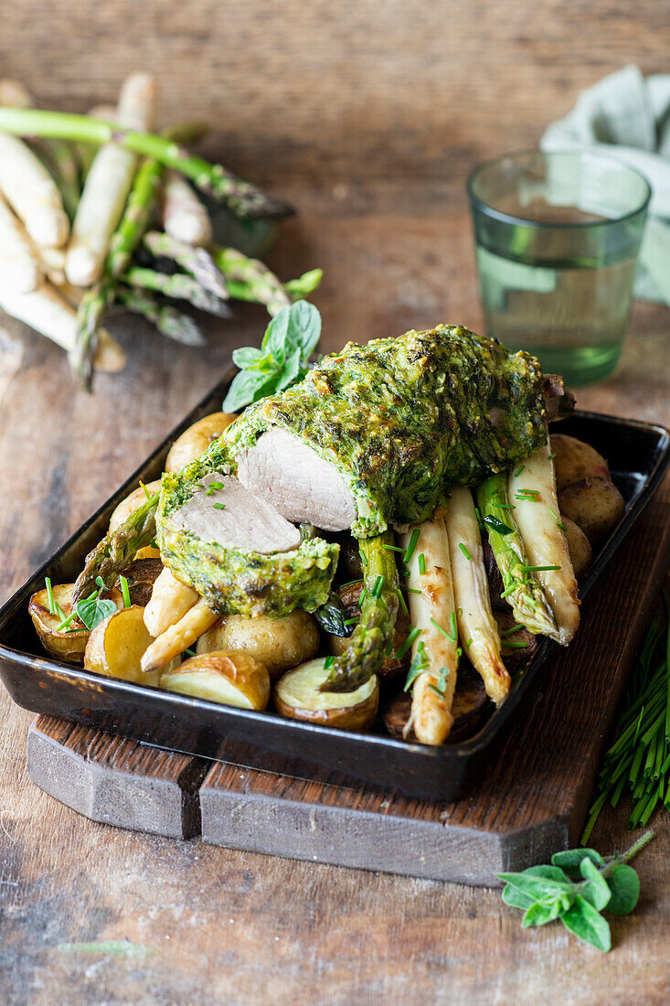 Pork fillet wrapped in herbs with asparagus and potatoes