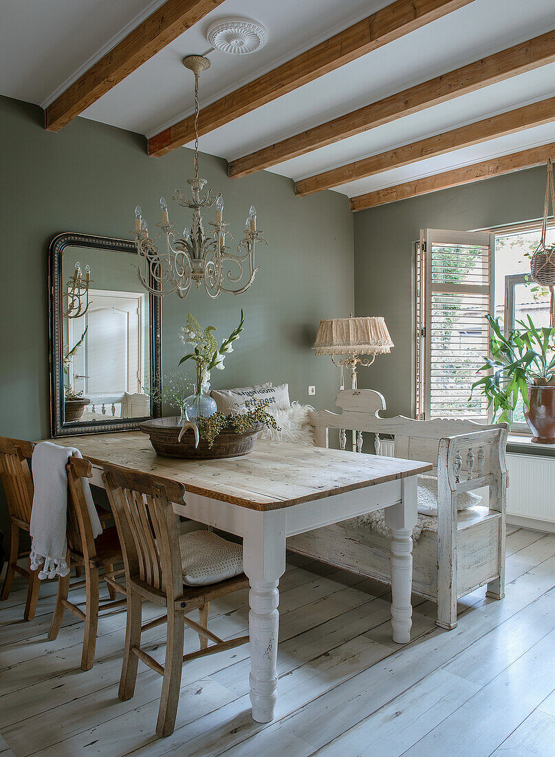 Dining room with rustic wooden table, wooden chairs and country-style bench