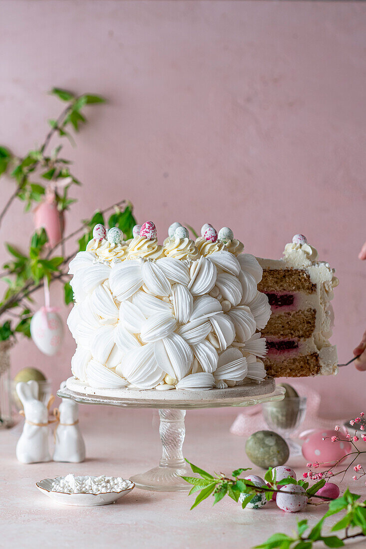 Raspberry cake with edible paper decoration and candy eggs