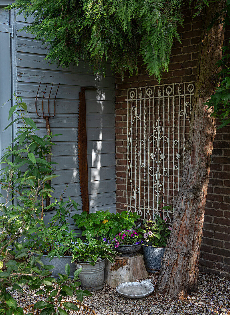 Garden area with planters, old tools and wall lattice decoration