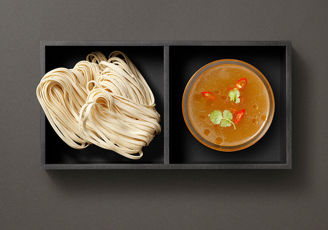 Tray with pasta and soup stock