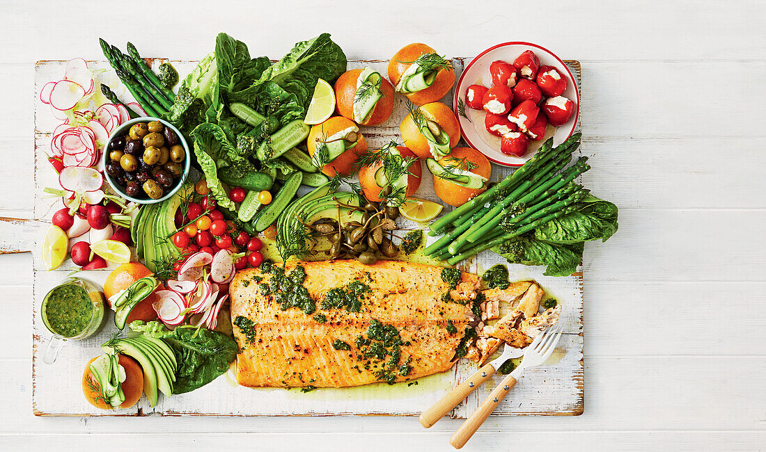 Baked salmon with vegetables and mini brioche on a wooden board